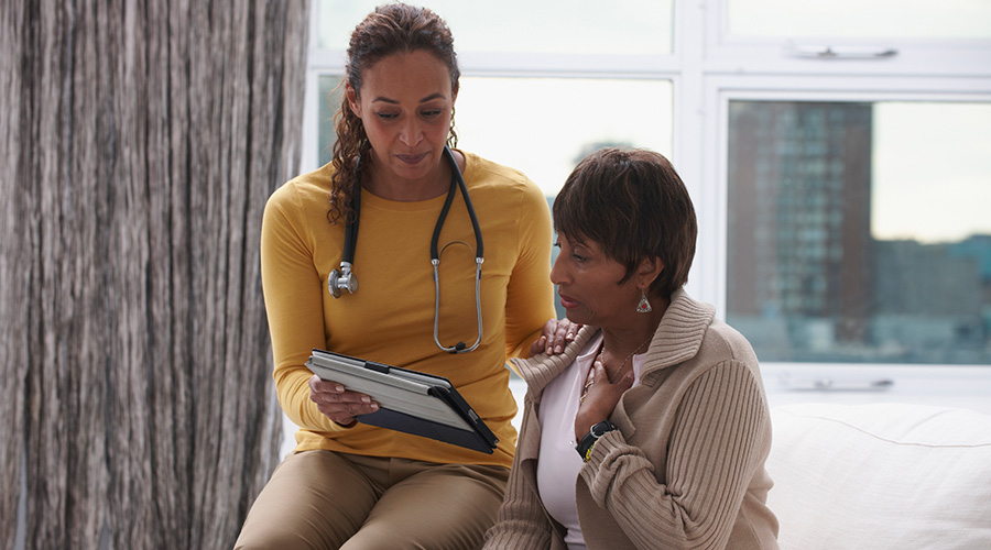 A female doctor (left) talking with a female patient