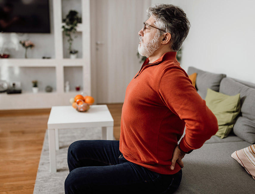 A man stretching his lower back. 