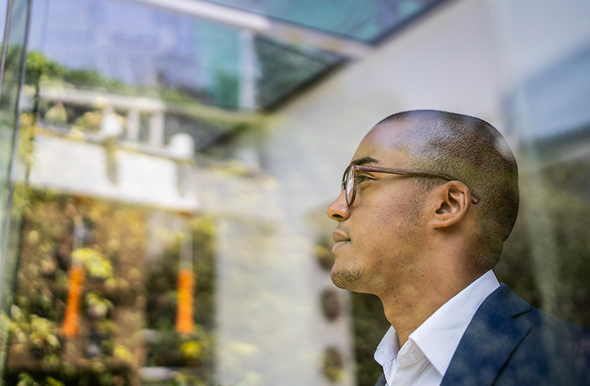 Side profile of a man through a window.