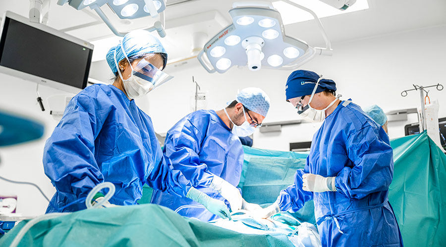 Surgeons performing surgery in an operating room.