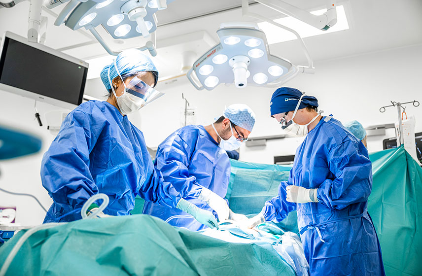 Surgeons performing surgery in an operating room.