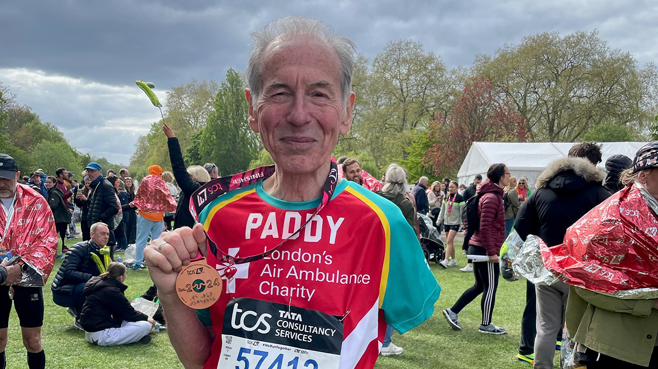 Patient, Paddy Pugh, wearing his medal after participating in the London marathon.